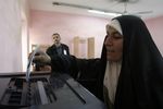 https://commons.wikimedia.org/wiki/File:US_Navy_051215-M-7772K-038_An_Iraqi_woman_prepares_to_cast_her_voting_ballot_into_one_of_the_bins_after_filling_it_out_at_a_polling_site_in_Rawah,_Iraq_during_the_country%27s_first_parliamentary_election.jpg
